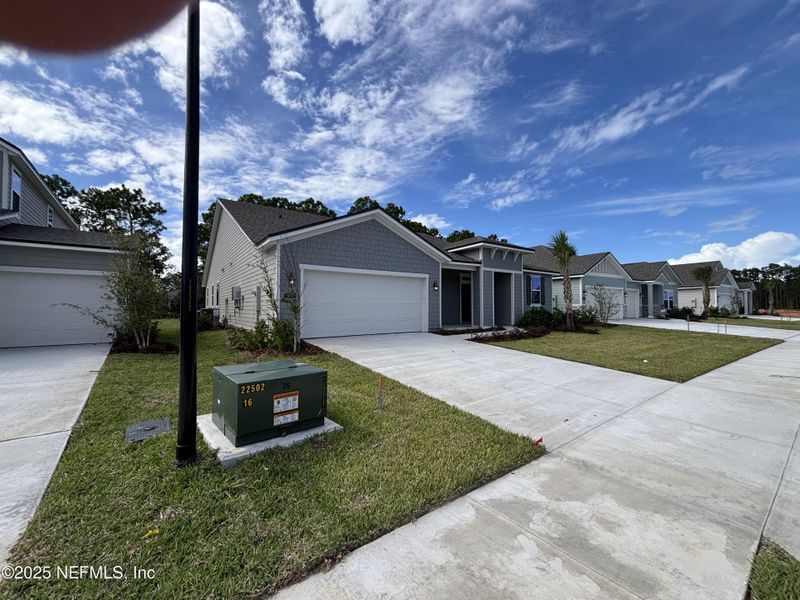 Front exterior of a new home in The Cypress Series at Reserve East, Flagler Beach, FL, highlighting curb appeal (Image 19).