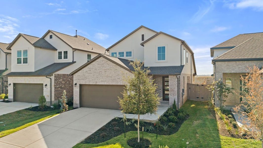 Front exterior of a new home in Flora, Hutto, TX, highlighting curb appeal (Image 2). Front exterior of a new home in Flora, Hutto, TX, highlighting curb appeal (Image 2).