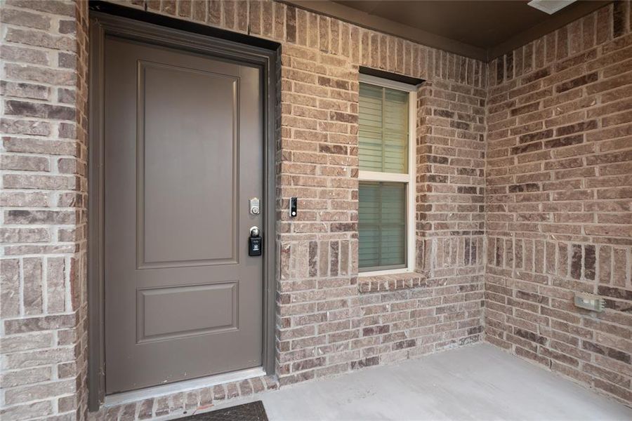 Doorway to property with brick siding