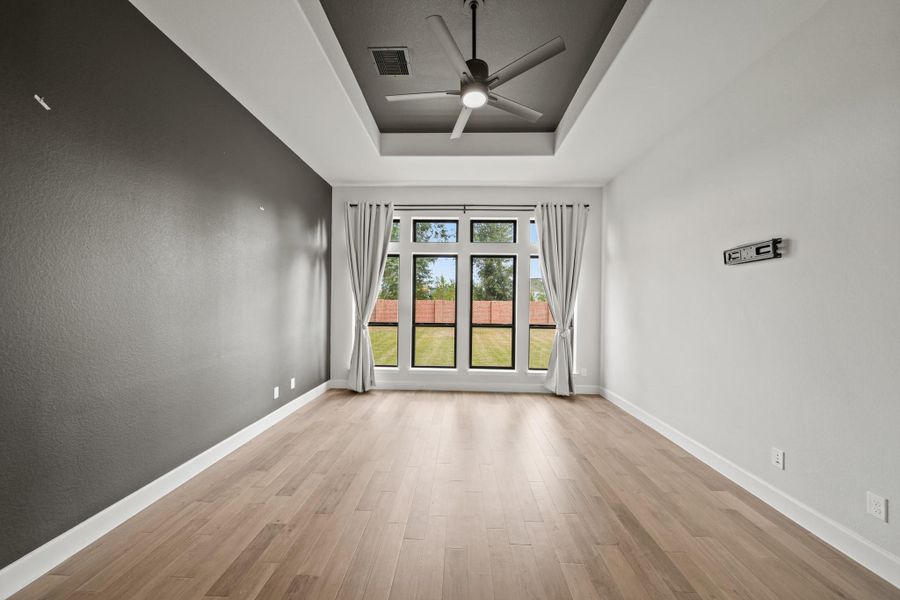 Primary bedroom is your retreat filled with natural light! Notice the tray ceiling and huge ceiling fan! Primary bedroom is your retreat filled with natural light! Notice the tray ceiling and huge ceiling fan!