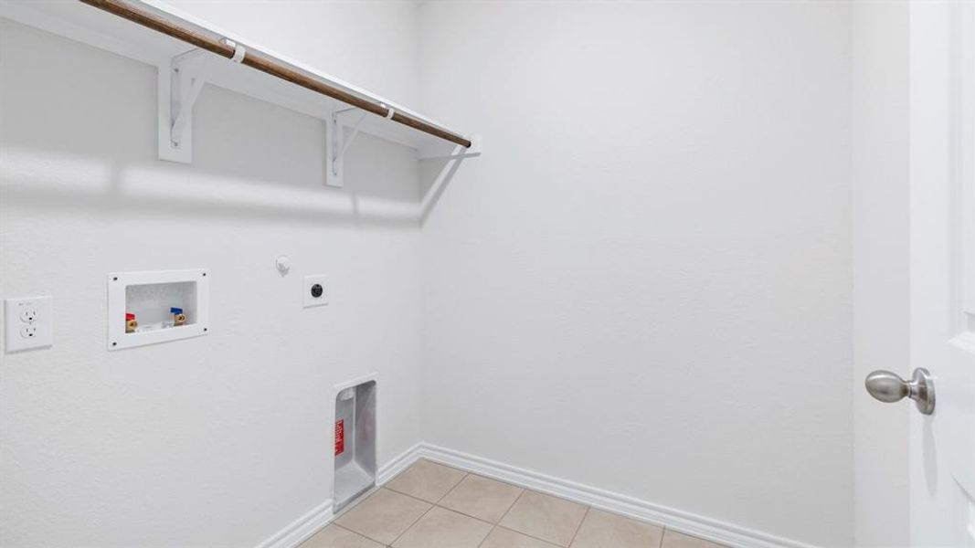 Laundry room featuring gas dryer hookup, washer hookup, light tile patterned flooring, and electric dryer hookup