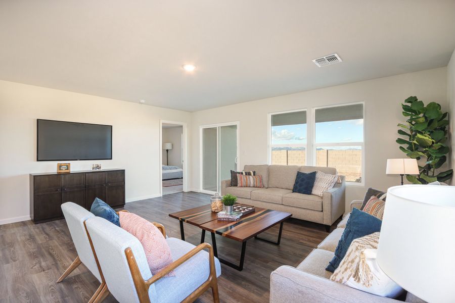 A living room with a tv and couches. A living room with a tv and couches.