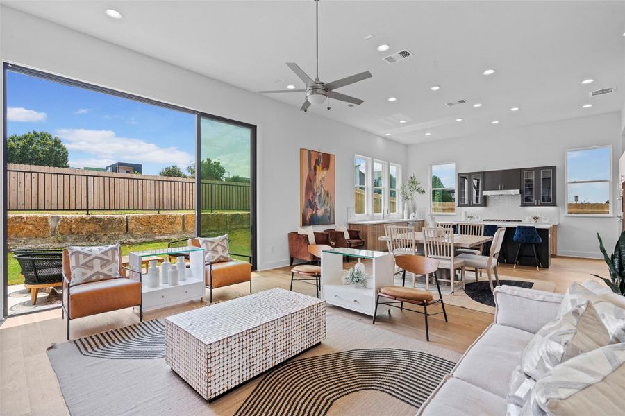 Oversized sliding doors cohesively blend the indoor/outdoor living of this amazing space.