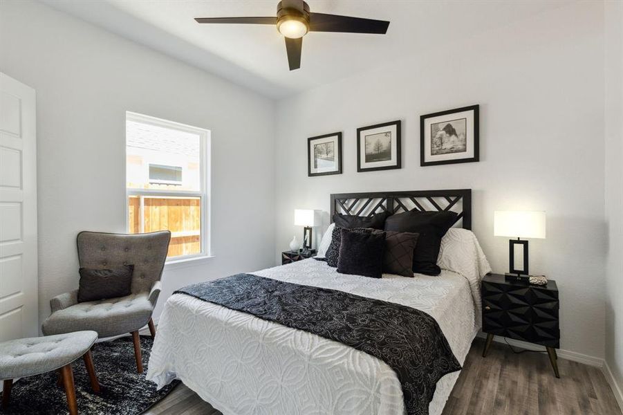 Bedroom featuring ceiling fan and hardwood / wood-style flooring