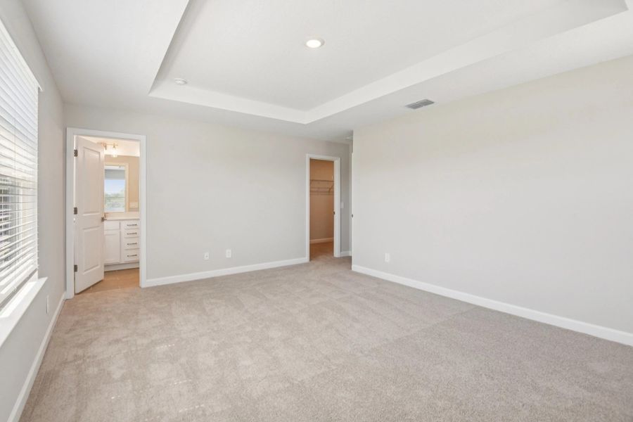 Primary bedroom features a walk-in closet separate from the primary bathroom