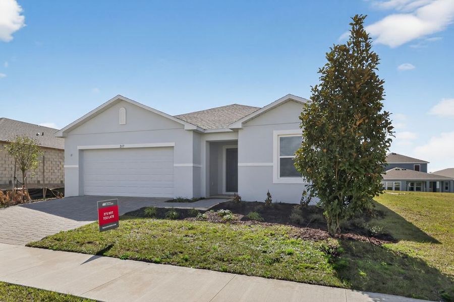 Front exterior of a new home in Waterstone, Groveland, FL, highlighting curb appeal (Image 19). Front exterior of a new home in Waterstone, Groveland, FL, highlighting curb appeal (Image 19).