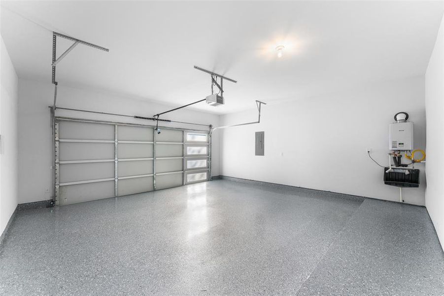 Garage with tankless water heater and electric panel