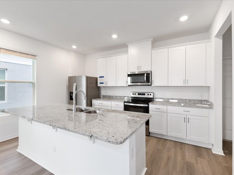 Kitchen in the Ellison floorplan at 4621 Cross Prairie Parkway in The Meadow at Crossprairie