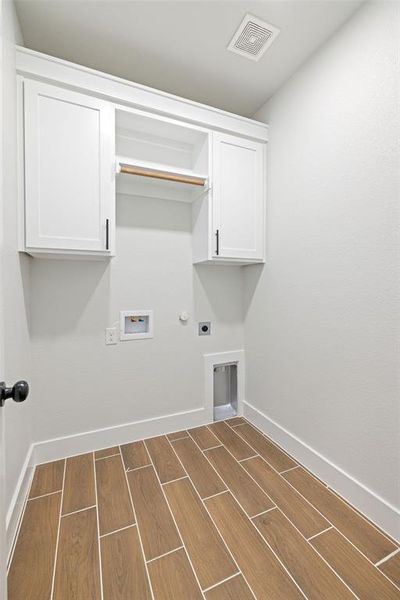 Laundry room featuring washer hookup, cabinets, hookup for an electric dryer, and gas dryer hookup