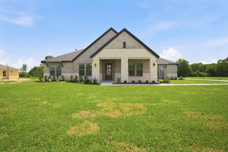 Front exterior of a new home in Chapel Bend, Montgomery, TX, highlighting curb appeal (Image 2). Front exterior of a new home in Chapel Bend, Montgomery, TX, highlighting curb appeal (Image 2).