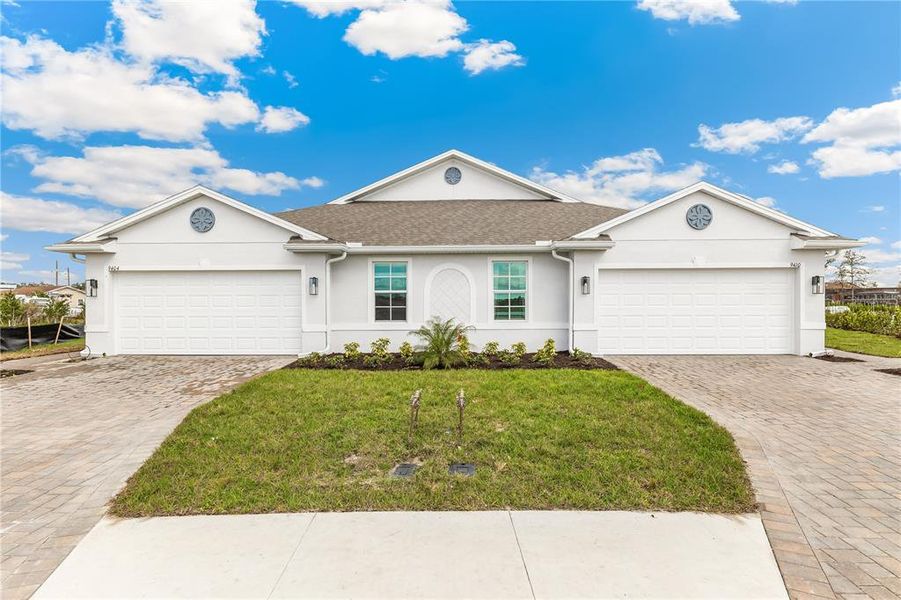 Front exterior of a new home in Sea Cove, Punta Gorda, FL, highlighting curb appeal (Image 2). Front exterior of a new home in Sea Cove, Punta Gorda, FL, highlighting curb appeal (Image 2).