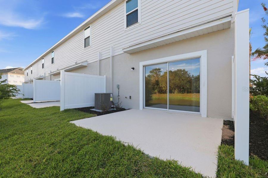 Exterior details and patio area of a home in The Towns at Firethorn, Parrish (Image 4).