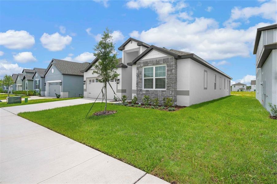 Front exterior of a new home in Gum Lake Preserve, Lake Alfred, FL, highlighting curb appeal (Image 17).
