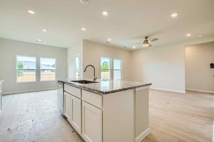 A kitchen with a marble island.