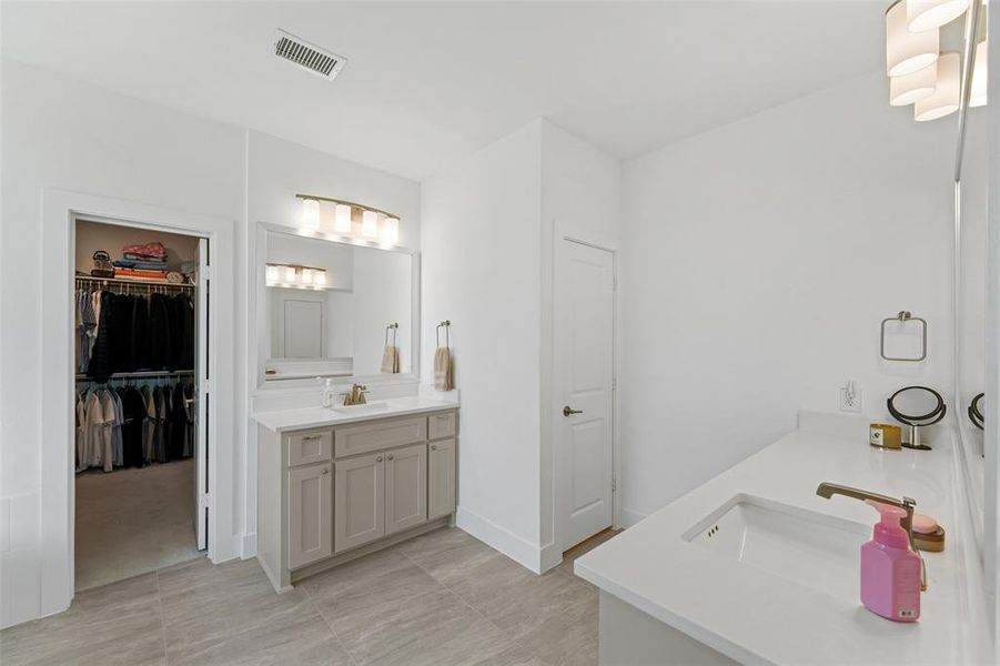 Ensuite Primary Bath features double sinks, walk in closet and toilet room