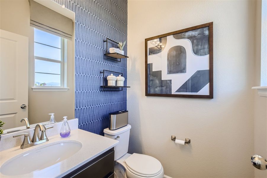 A bathroom with a blue wall. A bathroom with a blue wall.