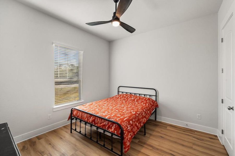 Bedroom featuring wood finished floors and ceiling fan