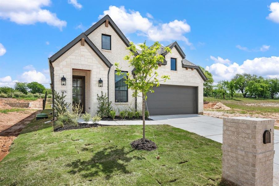 Front exterior of a new home in The Resort on Eagle Mt. Lake, Fort Worth, TX, highlighting curb appeal (Image 19). Front exterior of a new home in The Resort on Eagle Mt. Lake, Fort Worth, TX, highlighting curb appeal (Image 19).