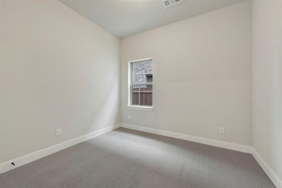 Empty room with carpet floors and baseboards