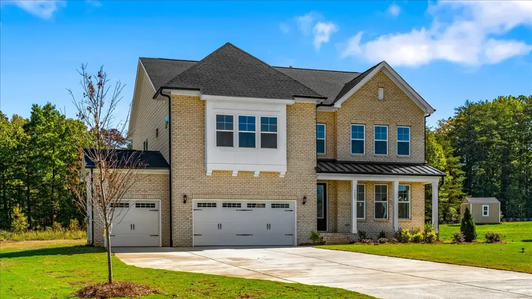 Front exterior of a new home in Lilah Grove, Summerfield, NC, highlighting curb appeal (Image 25). Front exterior of a new home in Lilah Grove, Summerfield, NC, highlighting curb appeal (Image 25).