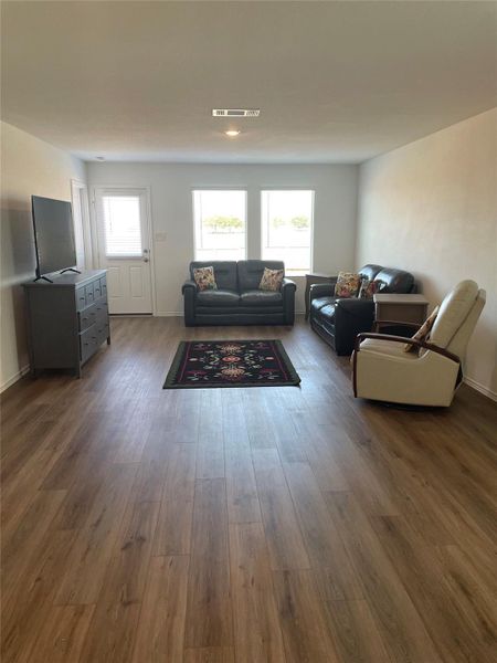 Living area with dark wood-type flooring