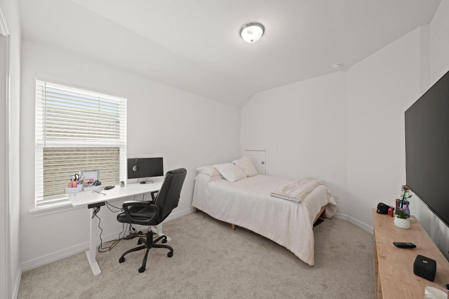 This secondary bedroom enjoys its own private bathroom. It's one of three secondary bedrooms.