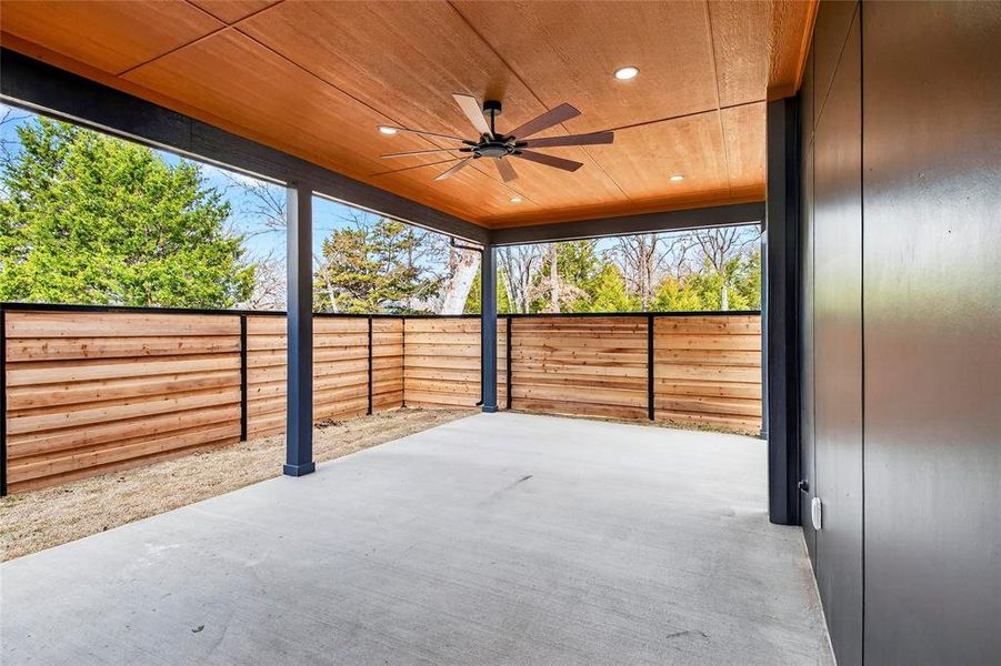 Fenced backyard featuring a ceiling fan and a patio Fenced backyard featuring a ceiling fan and a patio