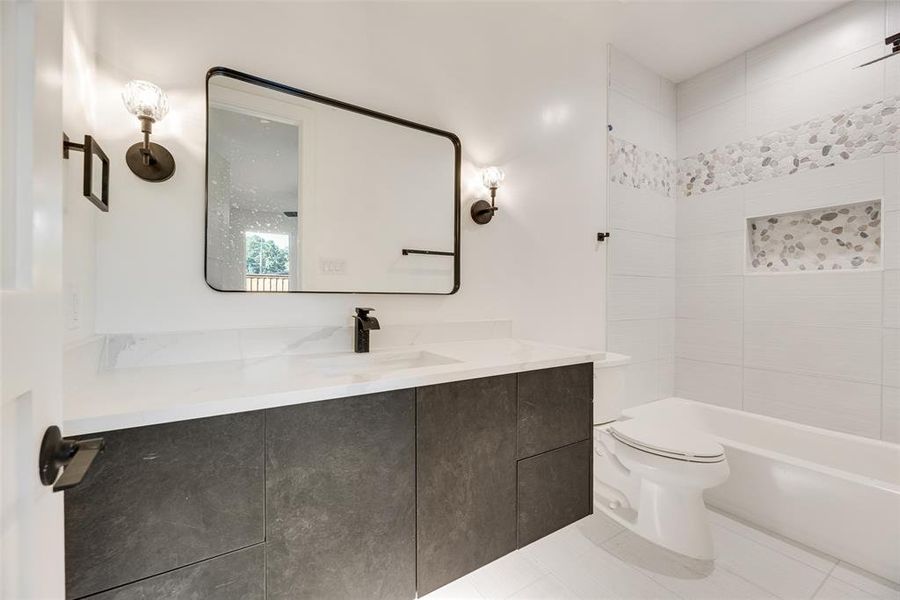 Full bath featuring vanity, light tile patterned floors, and bathtub / shower combination Full bath featuring vanity, light tile patterned floors, and bathtub / shower combination