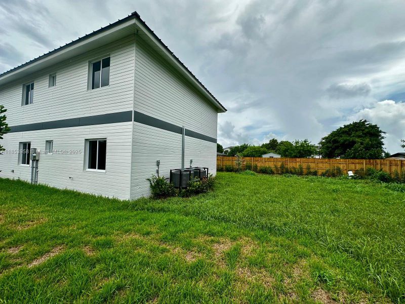 Front exterior of a new home in , Florida City, FL, highlighting curb appeal (Image 23). Front exterior of a new home in , Florida City, FL, highlighting curb appeal (Image 23).