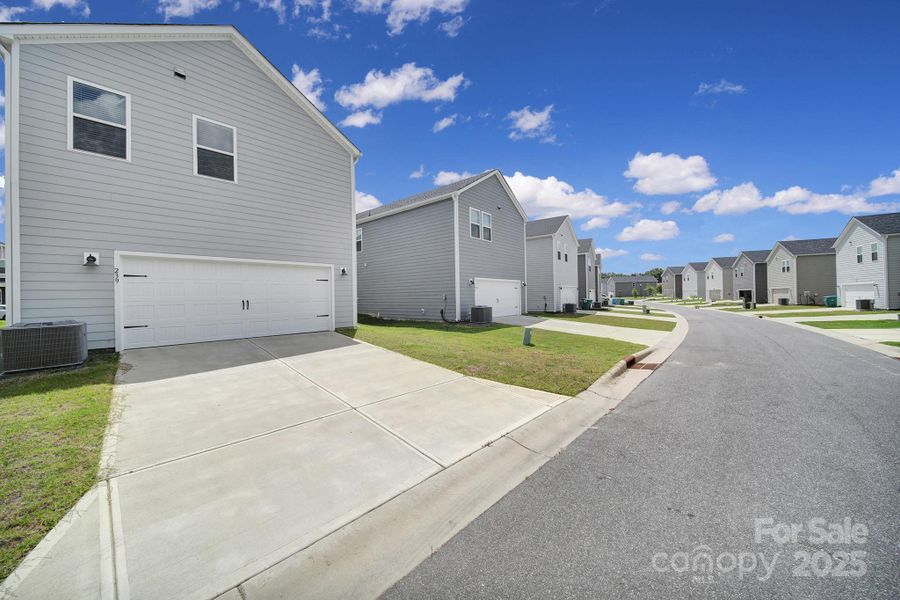 Front exterior of a new home in Preston Park, Pineville, NC, highlighting curb appeal (Image 17). Front exterior of a new home in Preston Park, Pineville, NC, highlighting curb appeal (Image 17).
