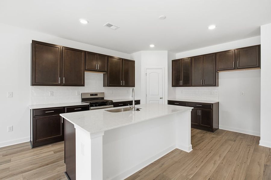 A kitchen with wooden cabinets. A kitchen with wooden cabinets.