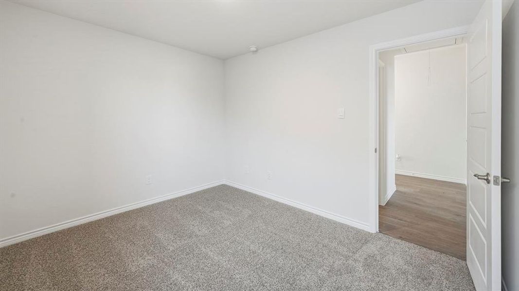 This room features light-colored walls and grey carpet flooring