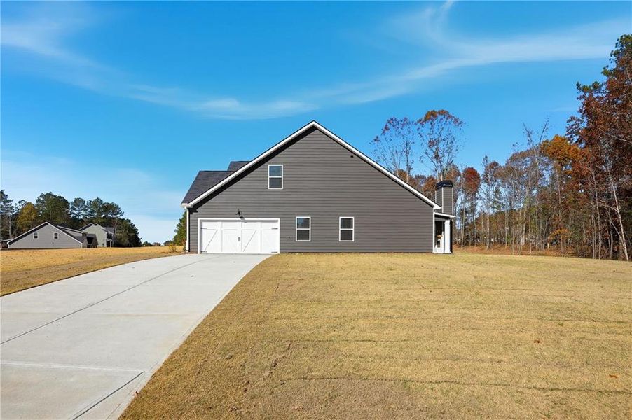Front exterior of a new home in The Woodlands Preserve, Jackson, GA, highlighting curb appeal (Image 16).
