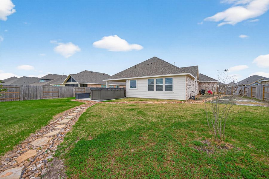 Spacious backyard with open lawn and fenced perimeter