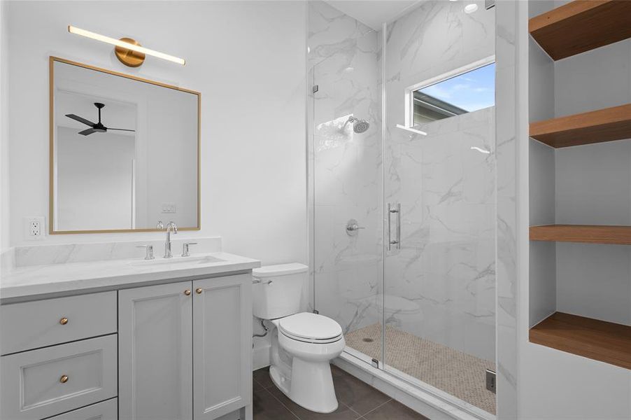 Private en suite guest bath. Notice the extra designer touch with white oak shelving maximizing style and function