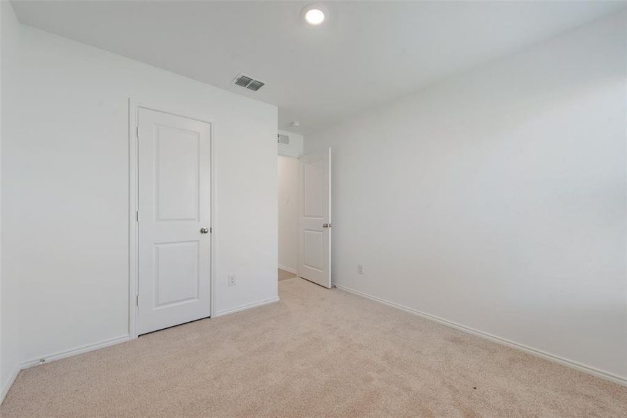 Unfurnished bedroom featuring light colored carpet