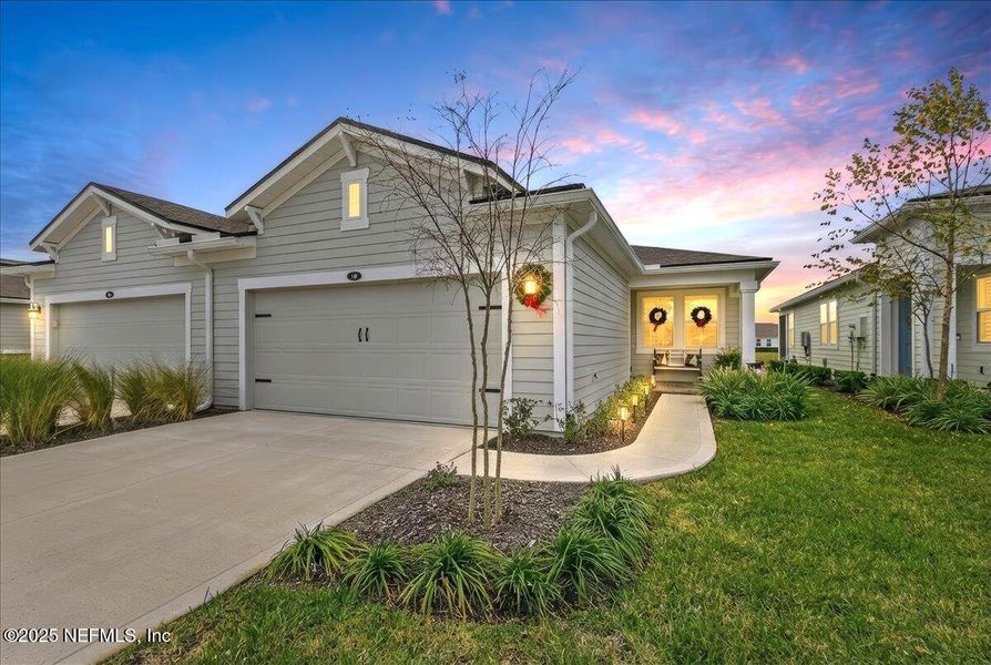 Front exterior of a new home in RiverTown - WaterSong, St. Johns, FL, highlighting curb appeal (Image 21).