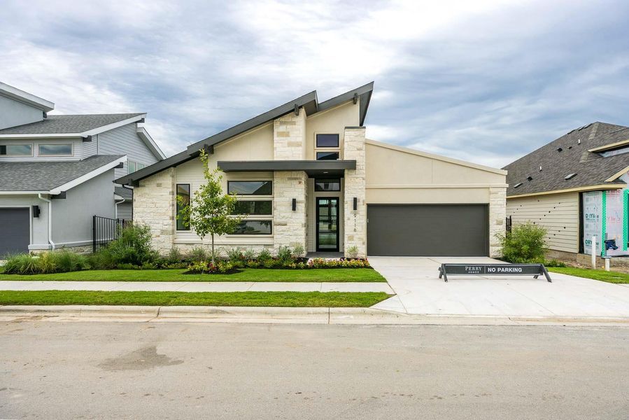 Contemporary house with stone siding, concrete driveway, a garage, and stucco siding Contemporary house with stone siding, concrete driveway, a garage, and stucco siding