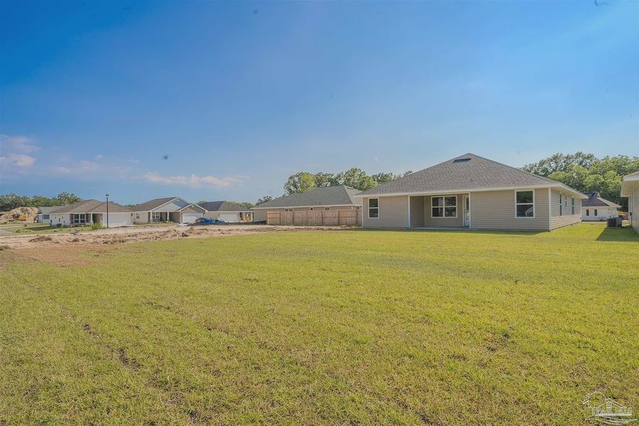 Front exterior of a new home in Pine Top, Cantonment, FL, highlighting curb appeal (Image 2).