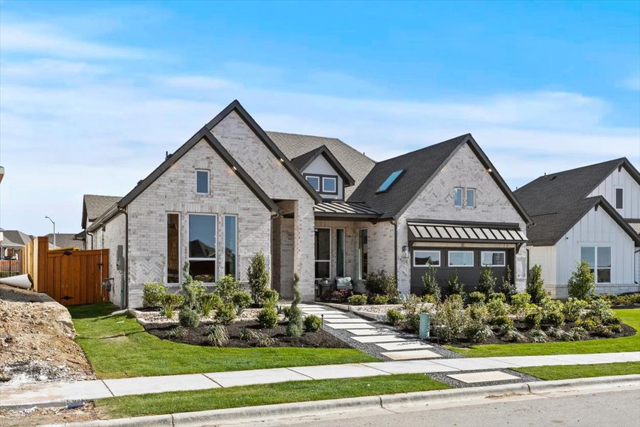 Front exterior of a new home in Lariat, Liberty Hill, TX, highlighting curb appeal (Image 1).