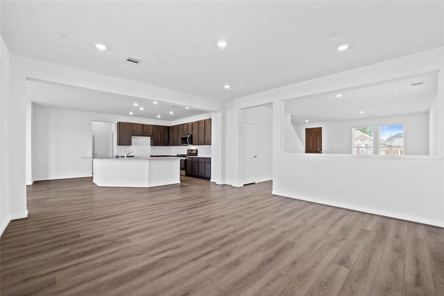 Stunning open-concept design seamlessly connecting the family, breakfast nook, and kitchen areas—perfect for both everyday living and entertaining!