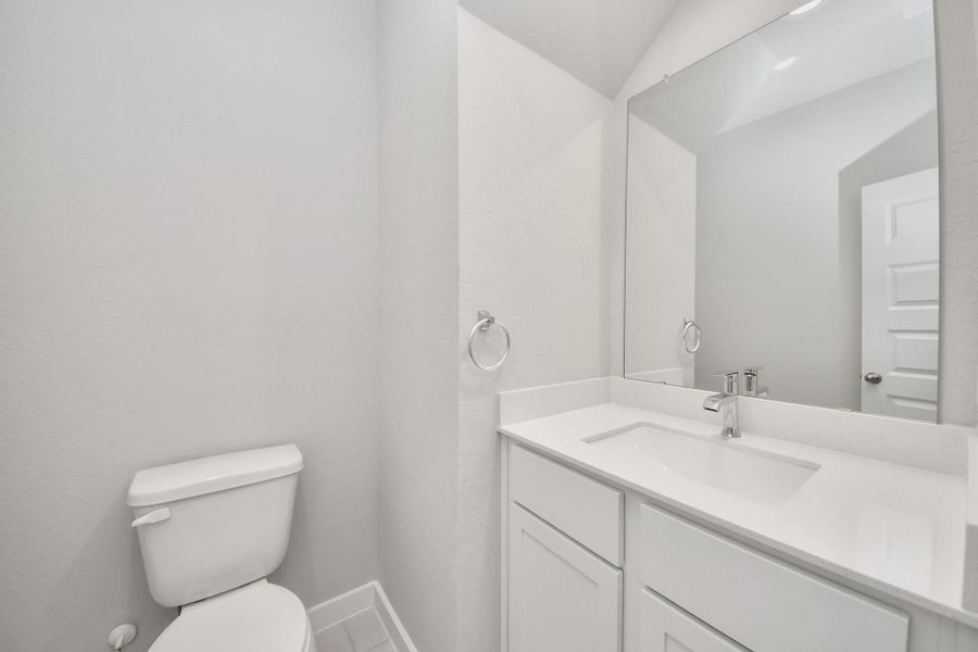This half bathroom features a stylish pedestal sink, modern hardware, and bright recessed lighting, creating a sleek and inviting space. Sample photo of completed home with similar floor plan. Actual colors and selections may vary. This half bathroom features a stylish pedestal sink, modern hardware, and bright recessed lighting, creating a sleek and inviting space. Sample photo of completed home with similar floor plan. Actual colors and selections may vary.