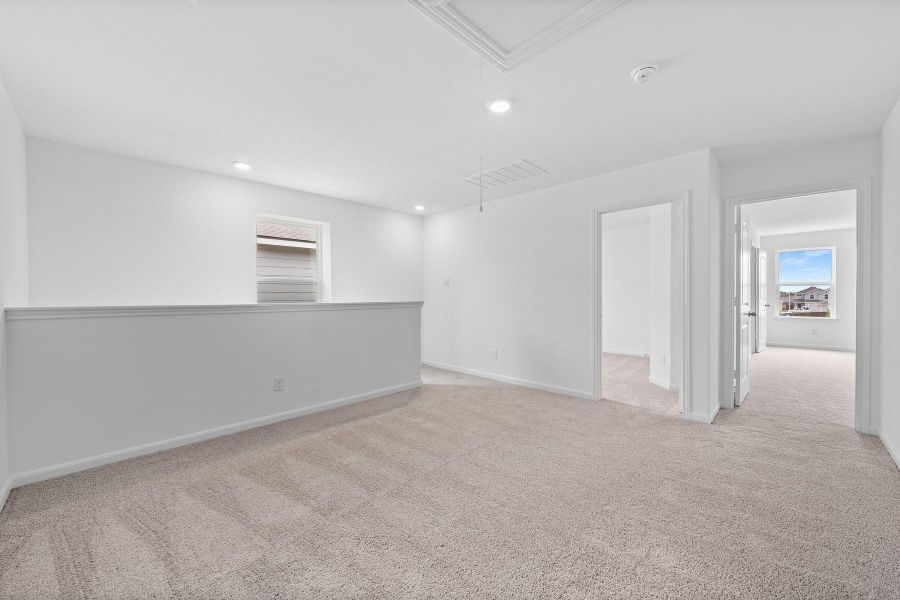 Spare room with light colored carpet and recessed lighting