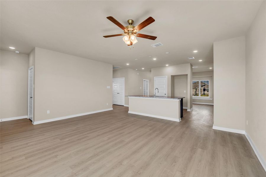 Unfurnished living room with recessed lighting, a ceiling fan, and light wood finished floors