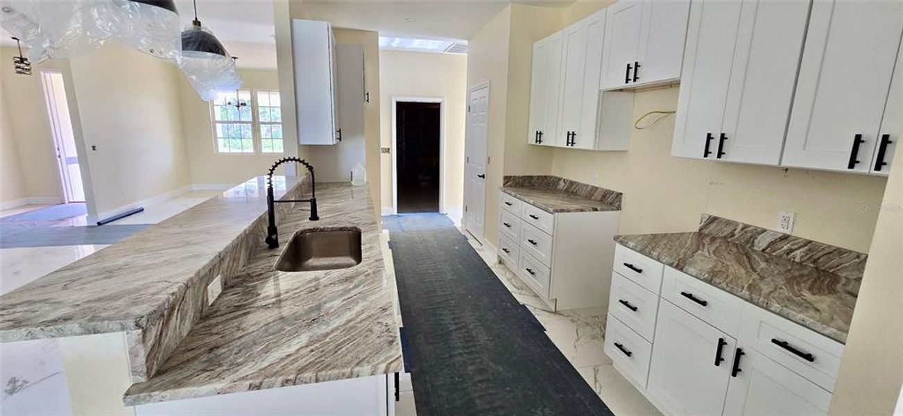 Kitchen with granite counter tops & plenty of cabinets, step up bar