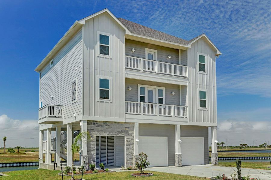 Beautiful coastal color exterior paint finish and stone accent wall & columns. Also includes gutters and built with wood pilings. Beautiful coastal color exterior paint finish and stone accent wall & columns. Also includes gutters and built with wood pilings.