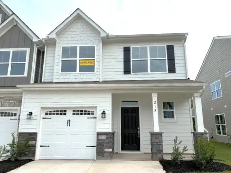 Front exterior of a new home in Riverbrooke Townhomes, Simpsonville, SC, highlighting curb appeal (Image 1). Front exterior of a new home in Riverbrooke Townhomes, Simpsonville, SC, highlighting curb appeal (Image 1).