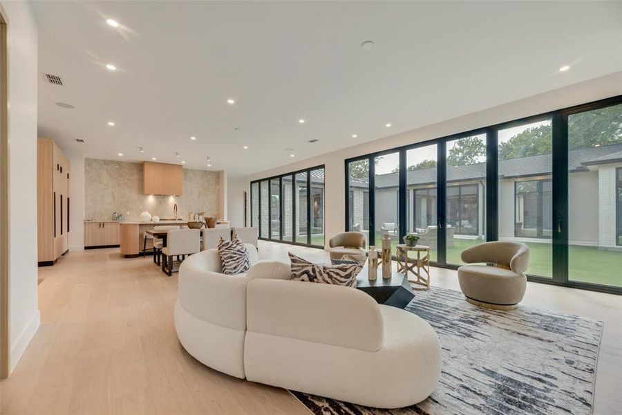 Living room with light hardwood / wood-style flooring and sink