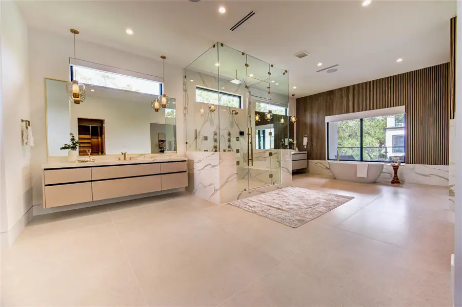 Spa-style primary bath with soaking tub and steam shower.