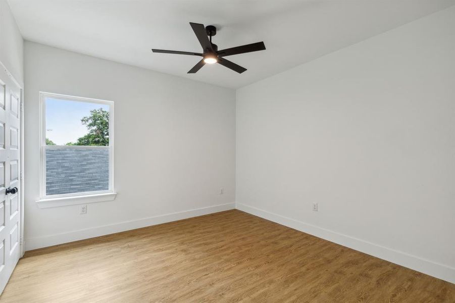 Empty room with light wood-type flooring and ceiling fan